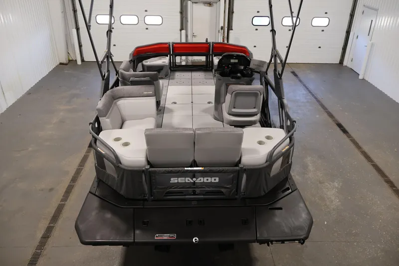 Slide: The Image of 2024 Sea-Doo Switch Cruise 18 pontoon boat in a showroom setting. - 9