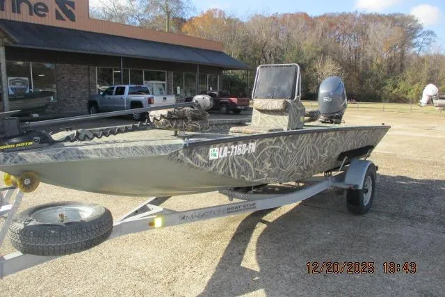 Slide: The Image of 2006 Lakesport 1860 CC boat on trailer, parked outdoors near a building. - 3