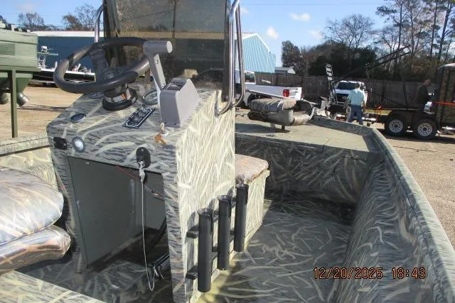 Slide: The Image of 2006 Lakesport 1860 CC boat with camouflage interior, parked outdoors. - 4