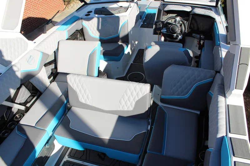 Slide: The Image of 2026 Tigé 24RZX boat interior with modern seating and steering wheel. - 14