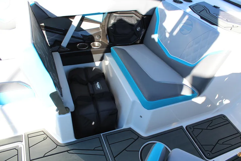 Slide: The Image of 2026 Tigé 24RZX boat interior with blue and gray seating, storage, and cup holders. - 16