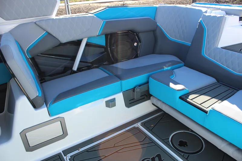 Slide: The Image of 2026 Tigé 24RZX boat interior with blue and gray seating, modern design. - 17