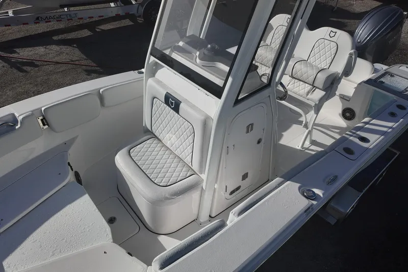 Slide: The Image of 2026 Sea Fox 228 Commander boat interior with cushioned seating and console. - 10