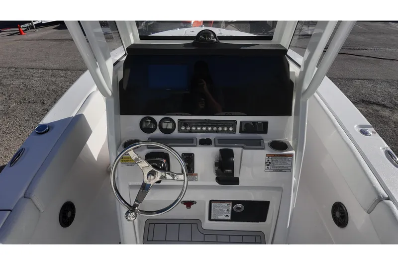 Slide: The Image of 2026 Sea Fox 228 Commander boat console with steering wheel and control panel. - 13