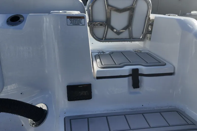 Slide: The Image of 2026 Sea Fox 228 Commander boat interior with storage compartment and safety warning label. - 17