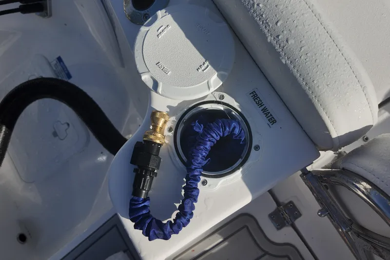 Slide: The Image of Freshwater connection on 2026 Sea Fox 228 Commander boat, featuring hose and fittings. - 18