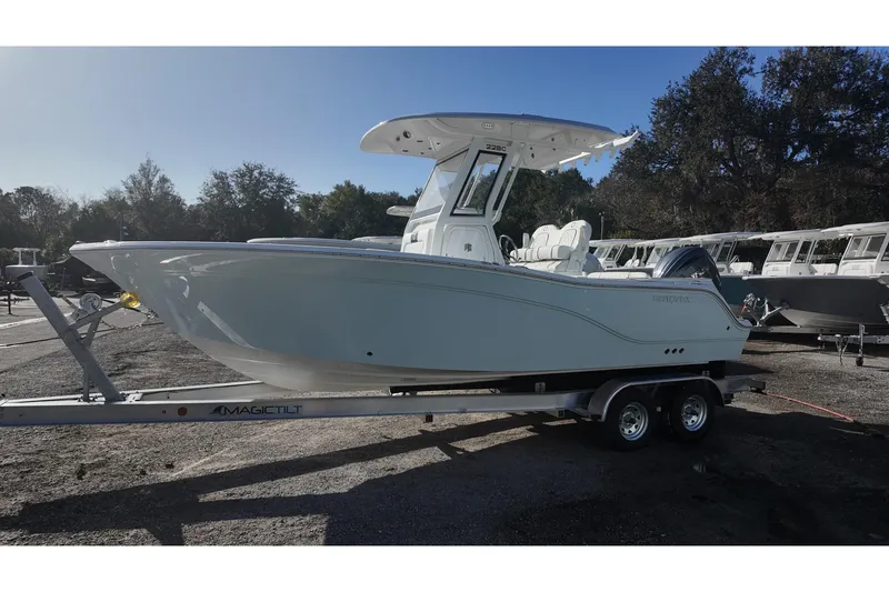 Slide: The Image of 2026 Sea Fox 228 Commander boat on trailer, parked outdoors. - 2