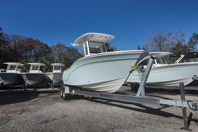 Slide: The Image of 2026 Sea Fox 228 Commander boat on trailer, parked outdoors under clear blue sky. - 3