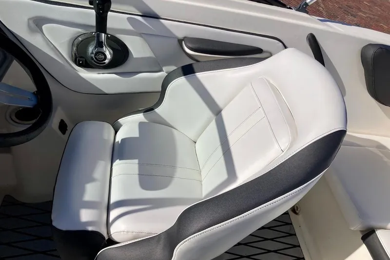 Slide: The Image of 2017 Sea Ray 19 SPX OB boat interior with white and black captain's seat. - 12