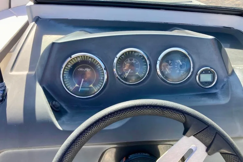 Slide: The Image of Dashboard of a 2017 Sea Ray 19 SPX OB boat with gauges and steering wheel. - 13
