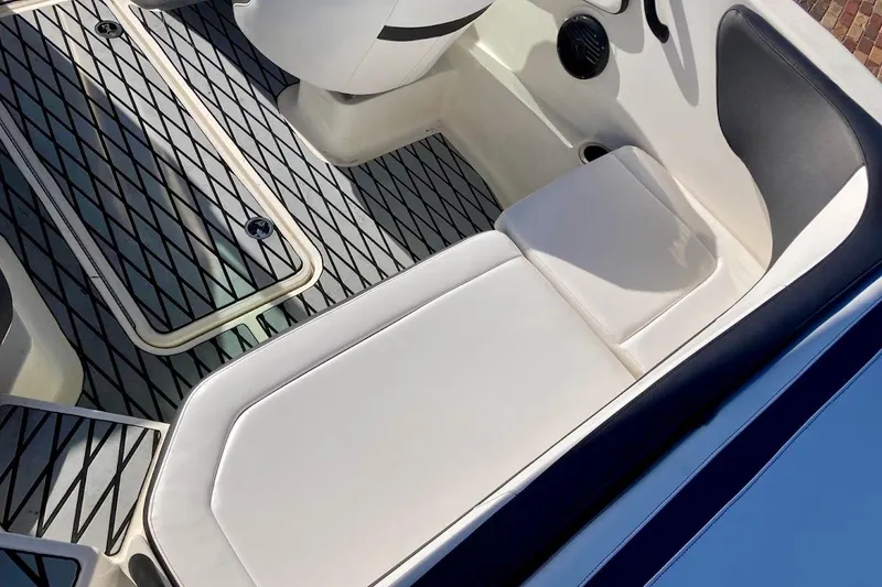 Slide: The Image of 2017 Sea Ray 19 SPX OB boat interior with cushioned seating and textured flooring. - 17