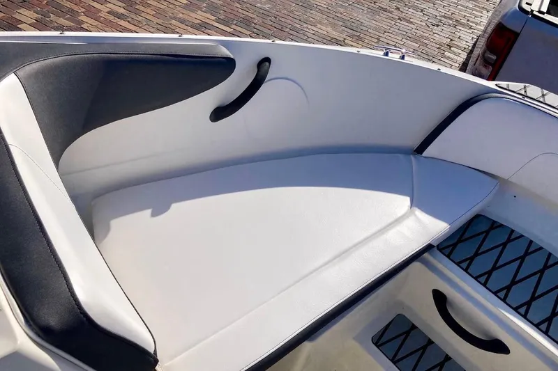 Slide: The Image of 2017 Sea Ray 19 SPX OB boat interior with white and black seating. - 19