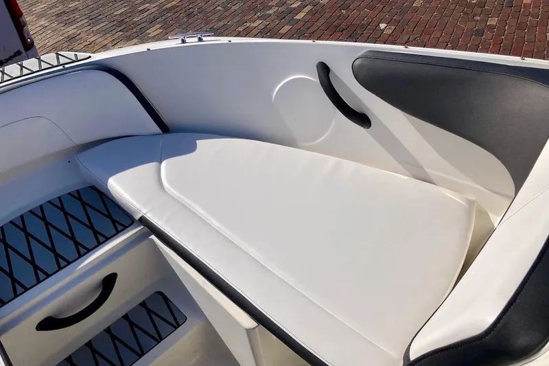 Slide: The Image of 2017 Sea Ray 19 SPX OB boat interior with white cushioned seating. - 20