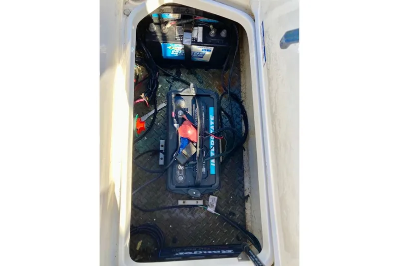 Slide: The Image of Battery compartment of 2017 Sea Ray 19 SPX OB boat, showing wiring and connections. - 22