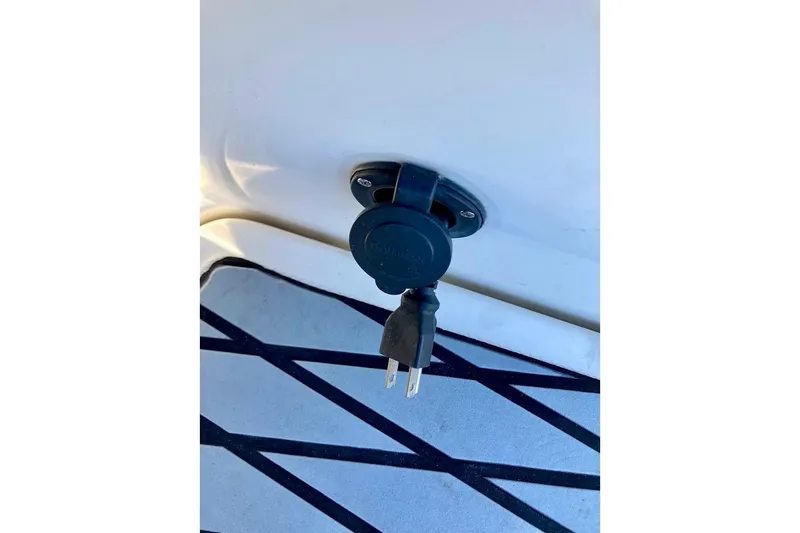 Slide: The Image of Power outlet on 2017 Sea Ray 19 SPX OB boat, featuring a plug connection. - 23
