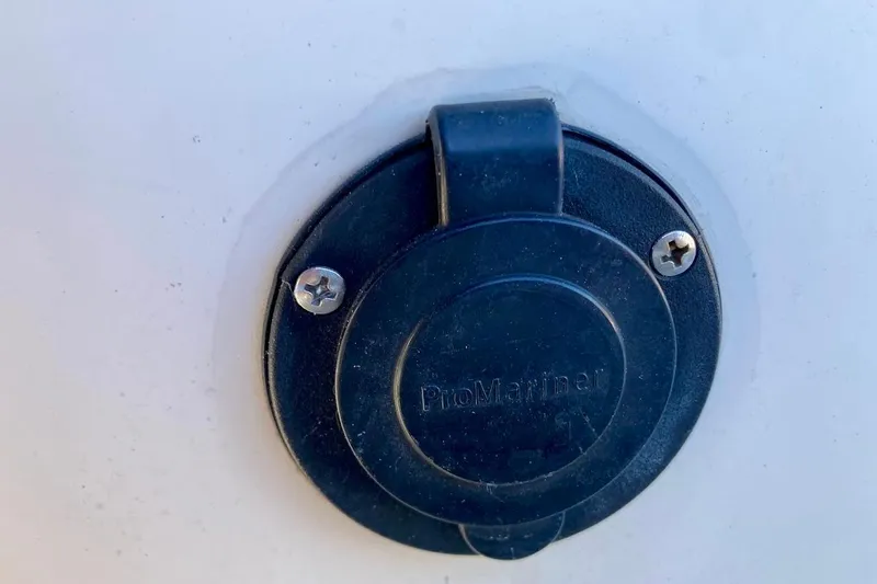 Slide: The Image of Close-up of a ProMariner outlet on a 2017 Sea Ray 19 SPX OB boat. - 24