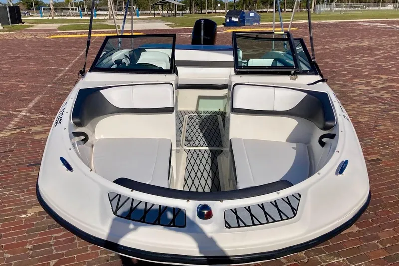 Slide: The Image of 2017 Sea Ray 19 SPX OB boat with open bow seating on brick pavement. - 26