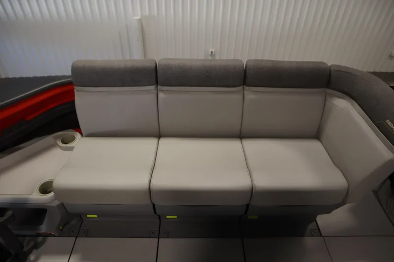 Slide: The Image of 2024 Sea-Doo Switch Cruise 21 interior seating with gray upholstery and cup holders. - 13