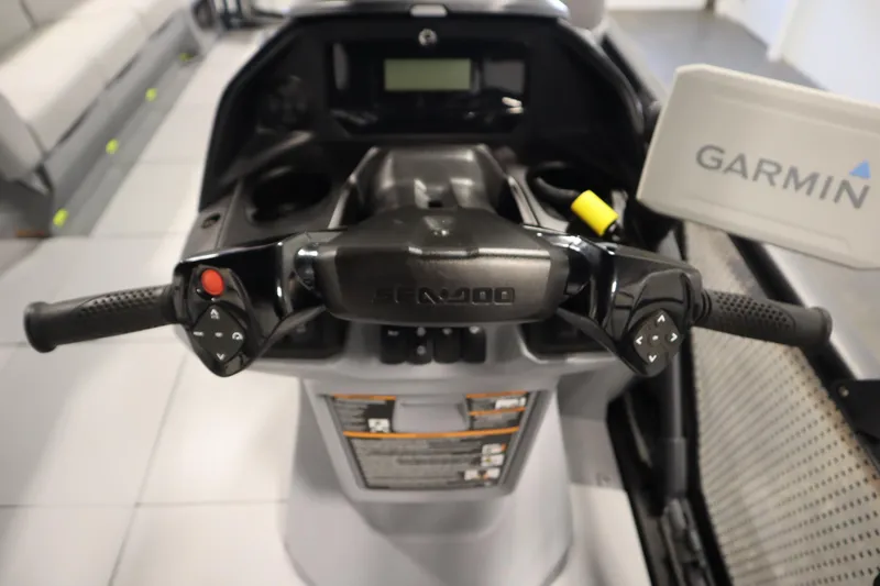 Slide: The Image of 2024 Sea-Doo Switch Cruise 21 dashboard with Garmin navigation system and control handles. - 18