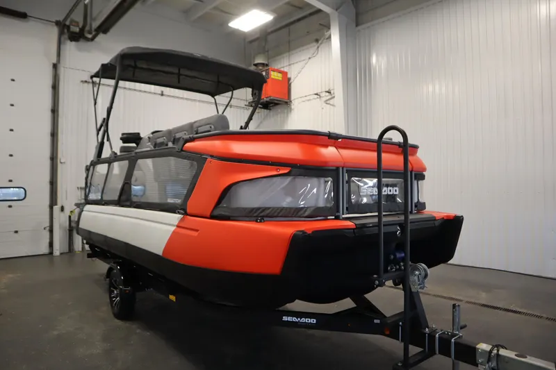 Slide: The Image of 2024 Sea-Doo Switch Cruise 21 in a garage, showcasing its vibrant design. - 2