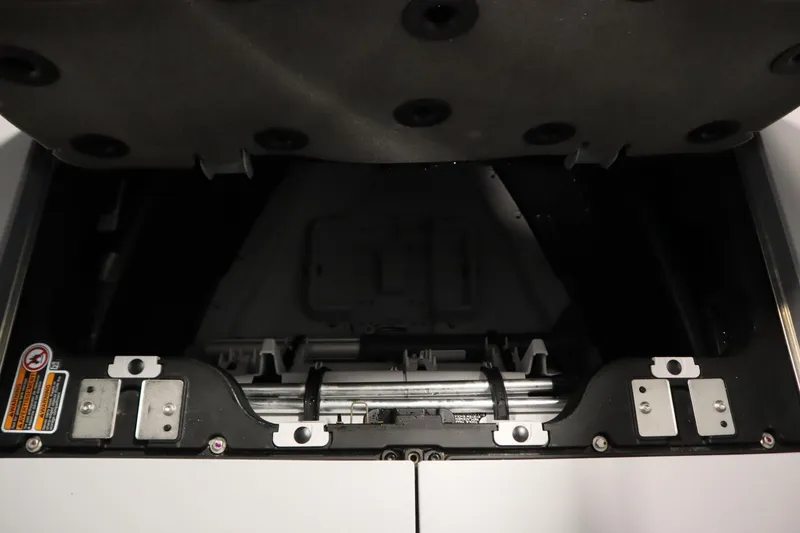 Slide: The Image of 2024 Sea-Doo Switch Cruise 21 storage compartment with open lid, showcasing interior details. - 30