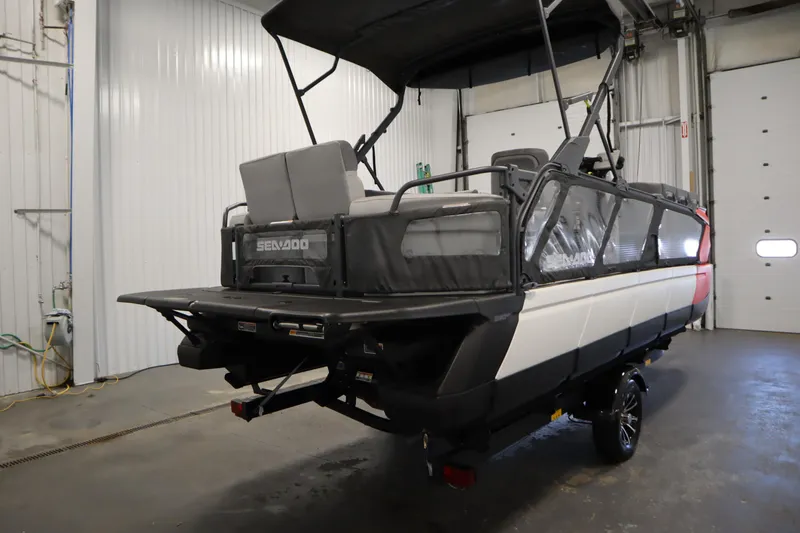 Slide: The Image of 2024 Sea-Doo Switch Cruise 21 pontoon boat in a garage setting. - 4
