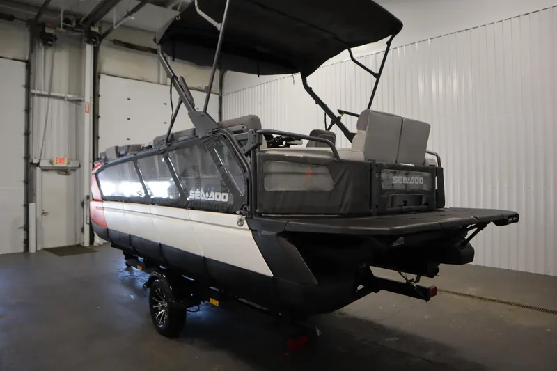 Slide: The Image of 2024 Sea-Doo Switch Cruise 21 pontoon boat in indoor storage facility. - 6