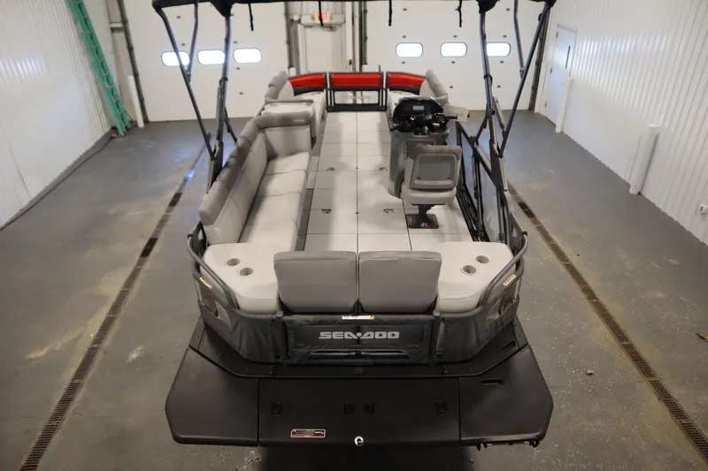 Slide: The Image of 2024 Sea-Doo Switch Cruise 21 pontoon boat in a garage setting. - 9