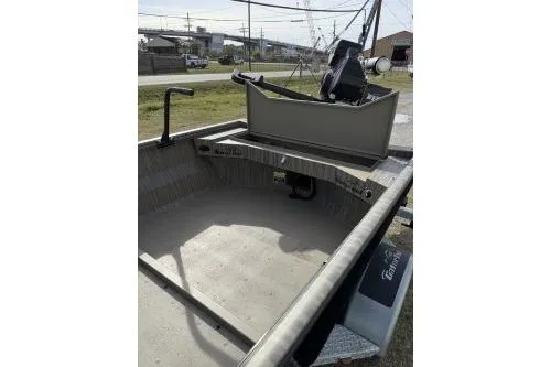 Slide: The Image of 2026 Gator Tail 1754 Extreme boat interior with steering console, parked outdoors. - 4