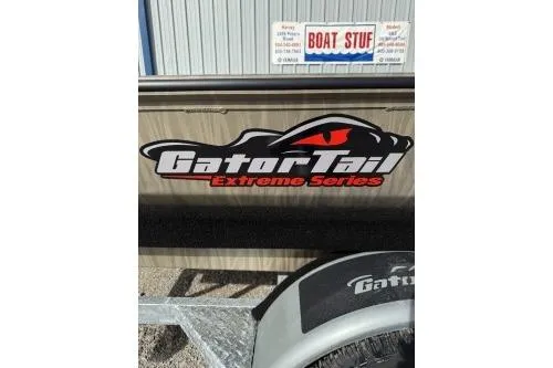 Slide: The Image of 2026 Gator Tail 1754 Extreme boat with logo and trailer in front of a store. - 8