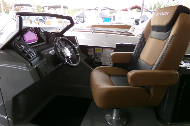 Slide: The Image of 2026 Sylvan L3 DLZ Bar boat interior with captain's chair and control panel. - 5