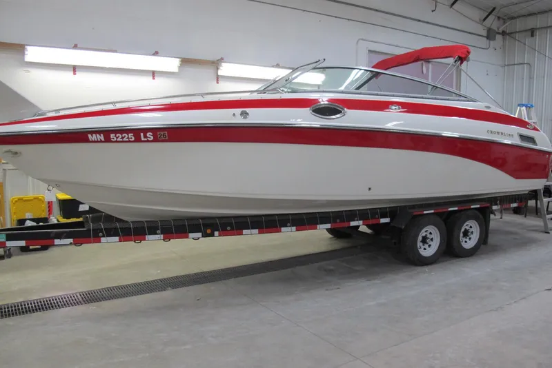 The Image of 2003 Crownline 270 BR boat on trailer in indoor storage facility. - 0