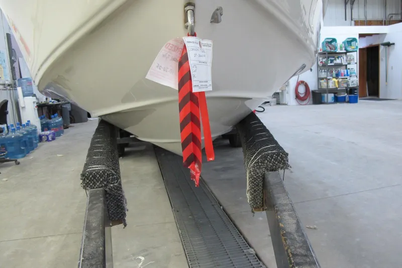 Slide: The Image of 2003 Crownline 270 BR boat on trailer in a garage setting. - 3