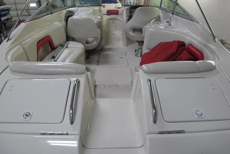 Slide: The Image of 2003 Crownline 270 BR boat interior with white seating and red accents. - 4