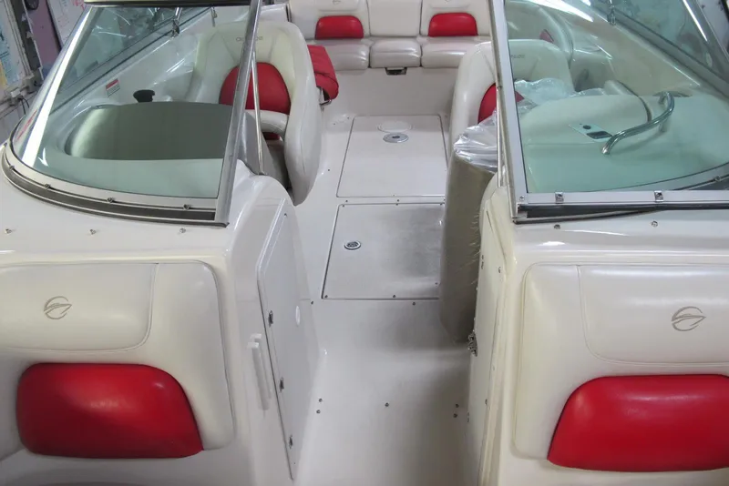 Slide: The Image of 2003 Crownline 270 BR boat interior with red and white seating, spacious layout. - 5