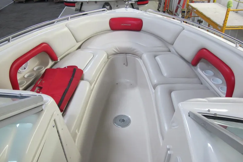 Slide: The Image of 2003 Crownline 270 BR boat interior with white and red seating, featuring cup holders. - 6