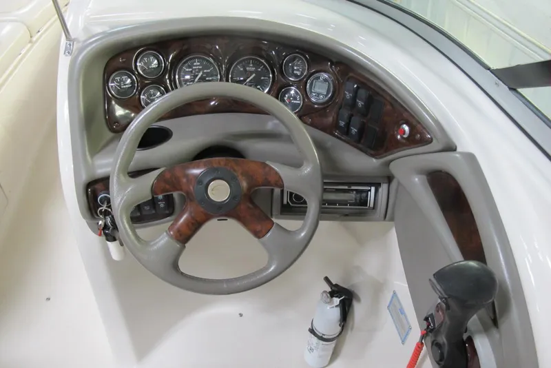 Slide: The Image of 2003 Crownline 270 BR boat dashboard with steering wheel and instrument panel. - 8