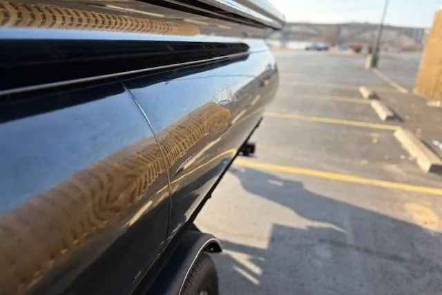 Slide: The Image of 2025 Regency 250 DL3 boat on trailer in parking lot, side view. - 19