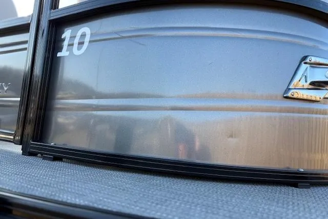 Slide: The Image of 2025 Regency 250 DL3 pontoon boat exterior with number 10, close-up view. - 21