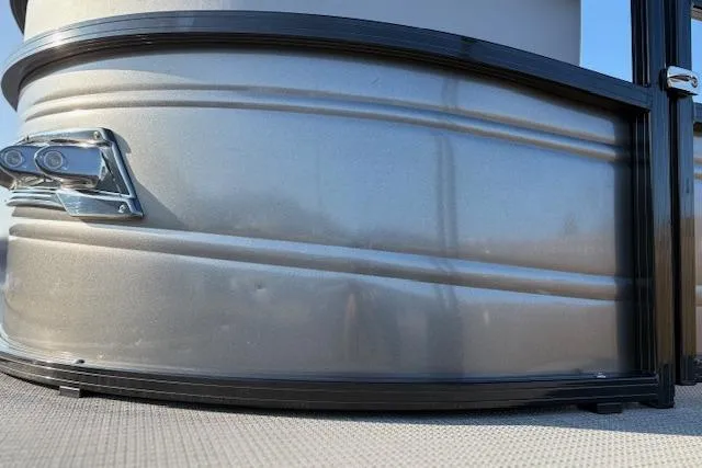 Slide: The Image of 2025 Regency 250 DL3 pontoon boat exterior detail with sleek metallic finish. - 22