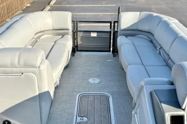Slide: The Image of 2025 Regency 250 DL3 pontoon boat interior with plush seating and spacious layout. - 31