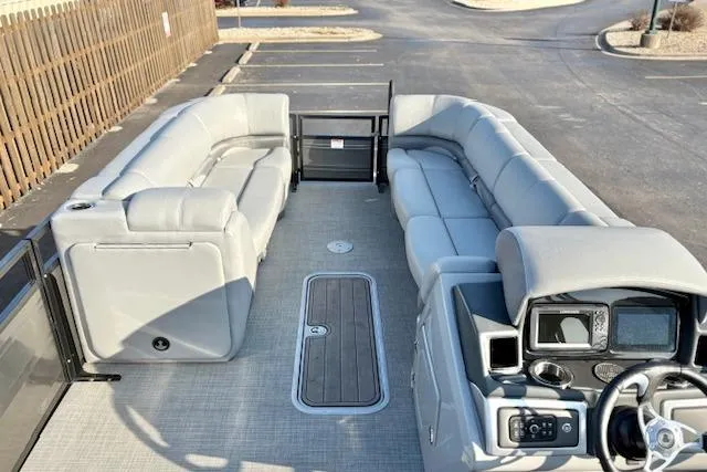 Slide: The Image of 2025 Regency 250 DL3 pontoon boat interior with spacious seating and modern dashboard. - 32