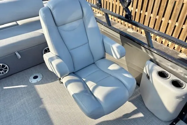 Slide: The Image of Luxurious seating on 2025 Regency 250 DL3 pontoon boat with cup holders and speakers. - 33