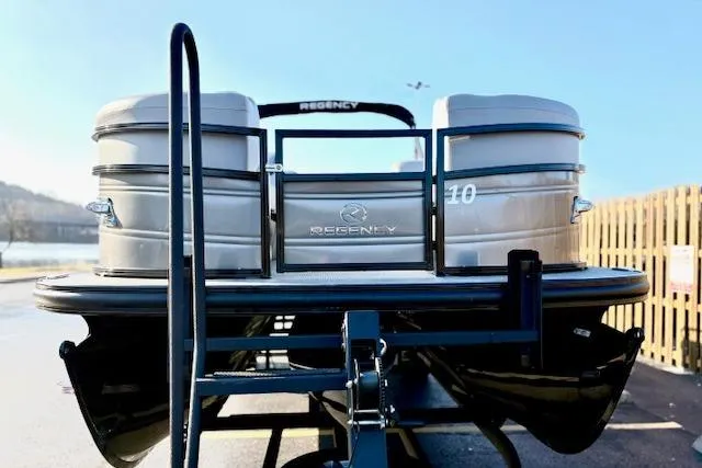 Slide: The Image of 2025 Regency 250 DL3 pontoon boat on trailer, rear view, sunny day. - 5