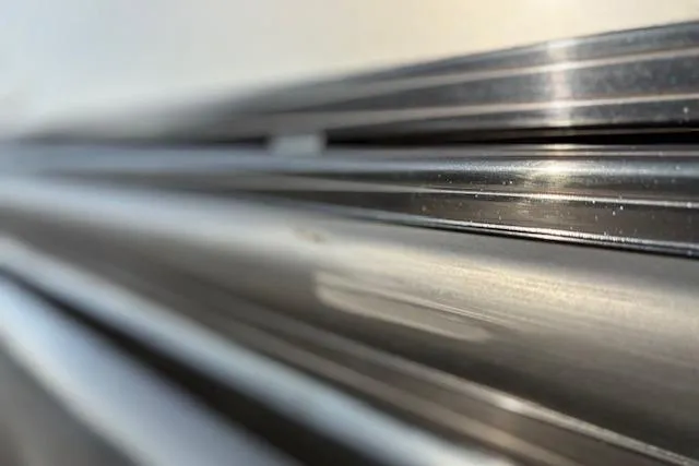 Slide: The Image of Close-up of 2025 Regency 250 DL3 metallic surface with sleek lines and reflections. - 8