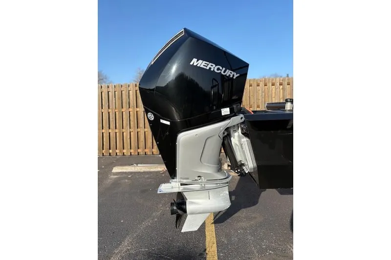 Slide: The Image of 2025 Regency 250 DL3 boat with Mercury outboard motor, parked outdoors. - 9