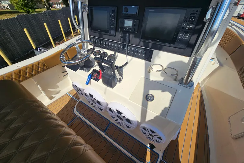 Slide: The Image of 2006 Key West 268 Center Console boat dashboard with navigation equipment and controls. - 11