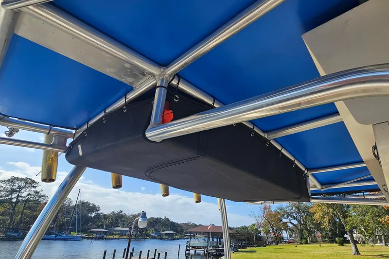 Slide: The Image of 2006 Key West 268 Center Console boat with blue canopy and stainless steel frame. - 17