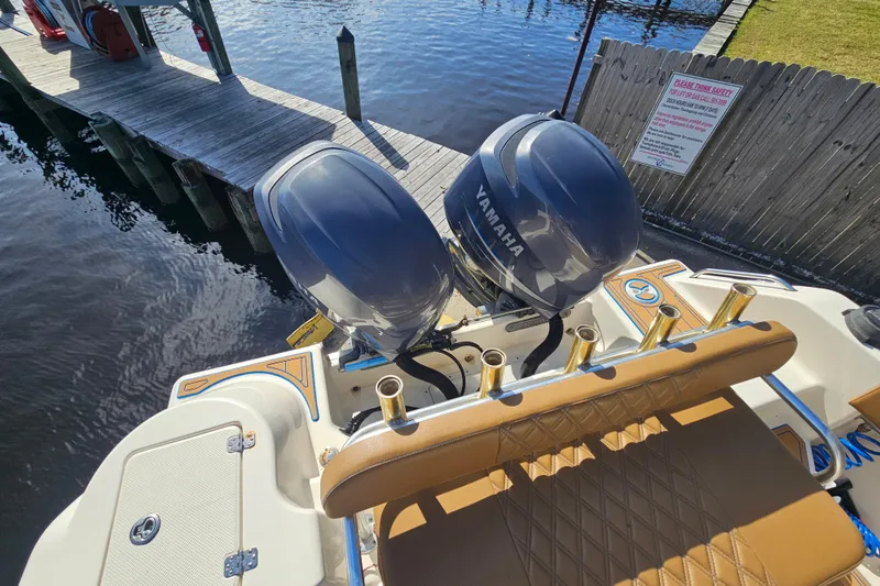 Slide: The Image of 2006 Key West 268 Center Console boat with Yamaha engines docked by wooden pier. - 18