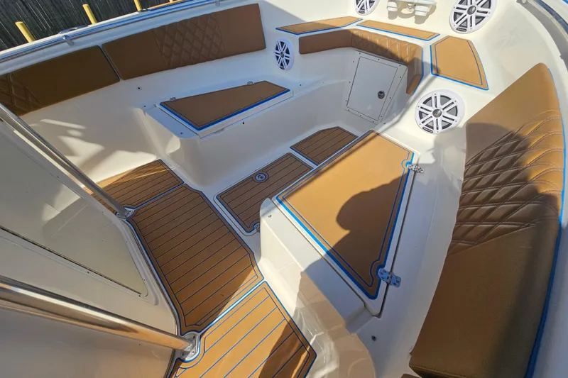 Slide: The Image of 2006 Key West 268 Center Console boat interior with tan seating and marine speakers. - 19